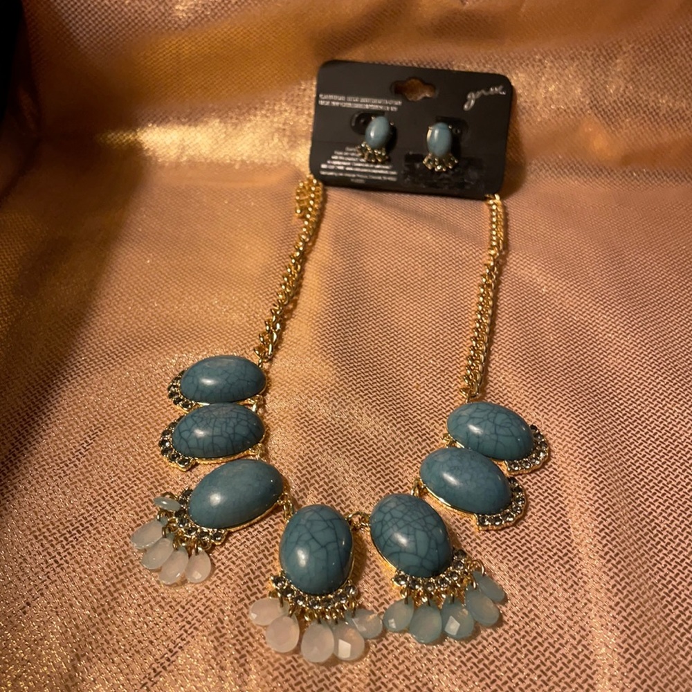 Necklace and earring set. Blue stones on gold colored chain